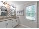 Bright bathroom featuring a double vanity, decorative mirrors and wallpaper, and a granite countertop at 2048 Mcafee Rd, Decatur, GA 30032