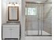 Bright bathroom featuring a sleek vanity and a modern tiled shower with glass doors at 2048 Mcafee Rd, Decatur, GA 30032