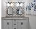 Bright bathroom featuring double vanity, decorative mirrors and wallpaper, and a granite countertop at 2048 Mcafee Rd, Decatur, GA 30032