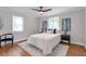 Bright bedroom with hardwood floors, ceiling fan, white bedding, and large windows at 2048 Mcafee Rd, Decatur, GA 30032