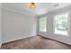 Well-lit bedroom featuring plush carpet and dual windows at 2048 Mcafee Rd, Decatur, GA 30032