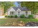 Charming painted brick home with landscaped front yard and mature trees at 2048 Mcafee Rd, Decatur, GA 30032