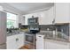 Well-equipped kitchen with stainless steel oven, sink, granite counter, and white cabinets at 2048 Mcafee Rd, Decatur, GA 30032