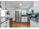 Modern kitchen with stainless steel appliances, granite countertops, and sleek white cabinetry at 2048 Mcafee Rd, Decatur, GA 30032
