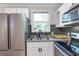 Modern kitchen with stainless steel refrigerator, granite countertops, and sleek white cabinetry at 2048 Mcafee Rd, Decatur, GA 30032