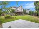 Fenced backyard with lush lawn, brick fireplace and wood deck overlooking the property at 2330 Springmonte Pl, Cumming, GA 30041