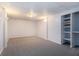 Finished basement with neutral walls, carpets, sconces, and built-in shelves at 2330 Springmonte Pl, Cumming, GA 30041
