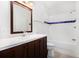 Bright bathroom with a dark wood vanity, white countertop, and a shower-over-tub with blue tile accent at 2330 Springmonte Pl, Cumming, GA 30041