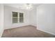 Neutral bedroom features a window, ceiling fan and wall-to-wall carpeting at 2330 Springmonte Pl, Cumming, GA 30041