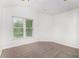 Bedroom featuring bright natural light, neutral carpet, and vaulted ceilings at 2330 Springmonte Pl, Cumming, GA 30041