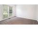 Cozy bedroom featuring neutral carpet, large window, and bright interior at 2330 Springmonte Pl, Cumming, GA 30041