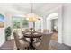 Elegant dining room featuring a chandelier, window, and dining set with seating for six at 2330 Springmonte Pl, Cumming, GA 30041