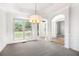 Elegant dining room featuring a chandelier, window, and bright interior at 2330 Springmonte Pl, Cumming, GA 30041