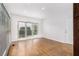 Bright living room featuring hardwood floors, large window, and natural light at 2330 Springmonte Pl, Cumming, GA 30041