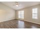 Bright bedroom features hardwood floors and two windows for natural light at 3151 Kingswood Gln, Decatur, GA 30034