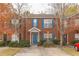 Charming brick townhome with blue shutters and door, complemented by mature landscaping and a concrete driveway at 3151 Kingswood Gln, Decatur, GA 30034