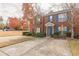 Attractive brick townhome features a blue front door and shutters, set against a lush green lawn at 3151 Kingswood Gln, Decatur, GA 30034