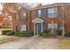 Inviting brick townhome with blue shutters, a well-maintained lawn, and a convenient concrete driveway at 3151 Kingswood Gln, Decatur, GA 30034