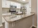 Well-lit kitchen featuring granite countertops, a stainless steel faucet, and white cabinets at 3151 Kingswood Gln, Decatur, GA 30034