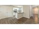 Kitchen and living area with modern gray flooring, stainless steel appliances, and white cabinets at 3151 Kingswood Gln, Decatur, GA 30034