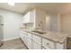 Kitchen with stainless steel appliances, granite countertops, white cabinets and gray wood-look flooring at 3151 Kingswood Gln, Decatur, GA 30034