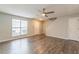 Sunlit living room with modern gray walls, sleek laminate flooring, and a contemporary ceiling fan at 3151 Kingswood Gln, Decatur, GA 30034