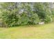The green and spacious backyard features mature trees and a storage shed at 3420 Leisure Ln, Atlanta, GA 30349
