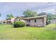 View of the property's green backyard, lush lawn, and rear exterior of the home at 3420 Leisure Ln, Atlanta, GA 30349
