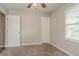 This bedroom has neutral walls, plush carpet, two doors, and a window for natural light at 3420 Leisure Ln, Atlanta, GA 30349
