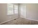 This bedroom features plush carpeting, a window letting in natural light and a closet for storage at 3420 Leisure Ln, Atlanta, GA 30349