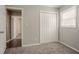 A bedroom featuring an open doorway, closet and window providing natural light at 3420 Leisure Ln, Atlanta, GA 30349