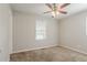 This bedroom has a ceiling fan, neutral colored walls, plush carpet, and natural light at 3420 Leisure Ln, Atlanta, GA 30349