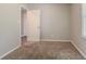 This bedroom has neutral paint, carpet, with an entrance to another room at 3420 Leisure Ln, Atlanta, GA 30349
