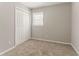 A bedroom featuring neutral walls, plush carpeting, closet and natural lighting at 3420 Leisure Ln, Atlanta, GA 30349