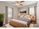 Well-lit main bedroom with modern decor, stylish furniture, windows, and carpet at 3420 Leisure Ln, Atlanta, GA 30349