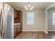 Bright dining area with stainless steel refrigerator, luxury vinyl plank flooring and natural light at 3420 Leisure Ln, Atlanta, GA 30349