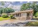 Charming brick home with mature trees, a well-manicured lawn, and a private driveway at 3420 Leisure Ln, Atlanta, GA 30349