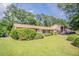 Attractive single-story home with a lush green lawn, mature trees, and a welcoming facade at 3420 Leisure Ln, Atlanta, GA 30349