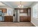 Modern kitchen featuring stainless steel appliances, wood cabinets, and luxury vinyl plank flooring at 3420 Leisure Ln, Atlanta, GA 30349