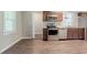 Updated kitchen featuring stainless steel appliances, wood cabinets, and luxury vinyl plank flooring at 3420 Leisure Ln, Atlanta, GA 30349