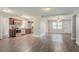 Open-concept kitchen with stainless steel appliances, wood cabinets, and luxury vinyl plank flooring at 3420 Leisure Ln, Atlanta, GA 30349