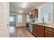Well-lit kitchen featuring stainless steel appliances and wood cabinets, overlooking an adjoining room at 3420 Leisure Ln, Atlanta, GA 30349