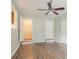 Hallway with access to laundry room, featuring white walls and wood-look floors at 3420 Leisure Ln, Atlanta, GA 30349