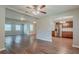 Open-concept living room and kitchen with stainless steel appliances and wood-look floors at 3420 Leisure Ln, Atlanta, GA 30349