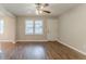 Bright living room features wood-look floors, a ceiling fan, and a neutral color scheme at 3420 Leisure Ln, Atlanta, GA 30349