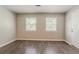 Bright living room with windows and wood-look floors at 3420 Leisure Ln, Atlanta, GA 30349