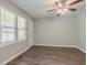 Bright living room features wood-look floors and a ceiling fan at 3420 Leisure Ln, Atlanta, GA 30349