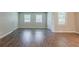 Bright living room with windows and wood-look floors at 3420 Leisure Ln, Atlanta, GA 30349