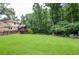 Spacious backyard with lush greenery, towering trees, and a well-manicured lawn, perfect for outdoor activities at 4366 Cedar Wood Sw Dr, Lilburn, GA 30047