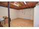 Unfinished basement area with wood floors, exposed ceiling, and ample storage space at 4366 Cedar Wood Sw Dr, Lilburn, GA 30047